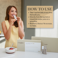 Woman taking a collagen sachet next to product boxes